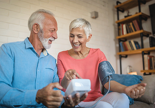 couple using blood pressure cuff